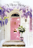 This photograph evokes the tender excitement of stepping up to a new home in Putney, where a pastel pink door, freshly painted and gently gleaming, stands under a canopy of cascading wisteria. The wisteria blooms drape in luxurious clusters of lavender and lilac, their small petals forming soft, tumbling strands that frame the doorway like a natural curtain. Above and around the door, the whitewashed wall reflects the daylight in a mellow, creamy tone, much like the façades of the townhouses scattered along streets near Putney Heath. To one side, a blush-coloured shutter is slightly open, echoing the pink of the door and suggesting an interior filled with light and air. On the stone step, a simple grey metal bucket has been elevated into a centrepiece, holding an abundant mix of white and cream roses. The roses are full and open, their velvety petals layered in generous spirals that create a sense of depth and softness. Between them, subtle touches of fresh green foliage bow outward, adding texture and a hint of garden wildness. Around the bucket, a soft pink ribbon is tied in a careful bow, its satin surface catching glimmers of light and its long tails resting gently against the step. Sunlight filters through the wisteria, leaving gentle dapples on the door and flowers, as if the day itself is blessing the moment. The atmosphere is quietly joyful and deeply welcoming, like a thoughtful housewarming gift delivered to a Putney doorstep, created to greet its new owners with fragrance, colour, and a sincere floral whisper of welcome home from Flowers Putney.